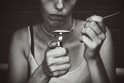 drugabuse_shutterstock-252469582-woman-heating-up-heroin-on-spoon-addict
